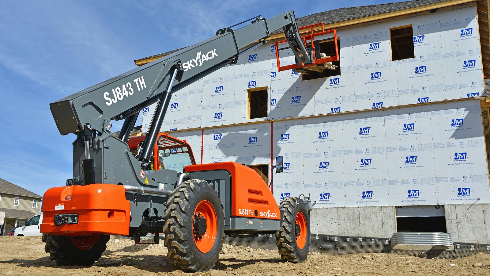 Pick-and-place telehandler on a busy jobsite